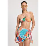 Emory Park model wearing a colorful Tangerine Bikini Bralette with tropical print and matching sarong