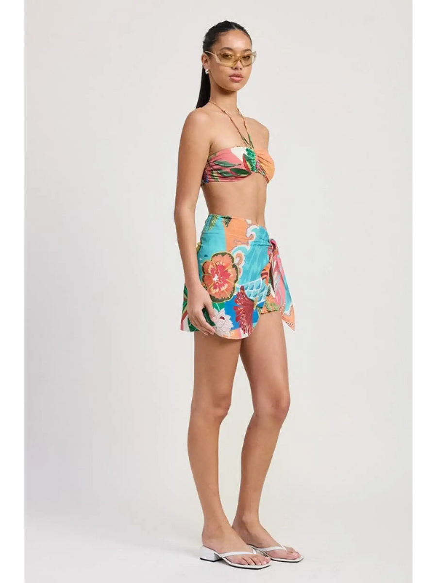 Emory Park model wearing a colorful Tangerine Bikini Bralette paired with a floral wrap skirt and flip-flops