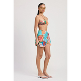 Emory Park model wearing a colorful Tangerine Bikini Bralette paired with a floral wrap skirt and flip-flops