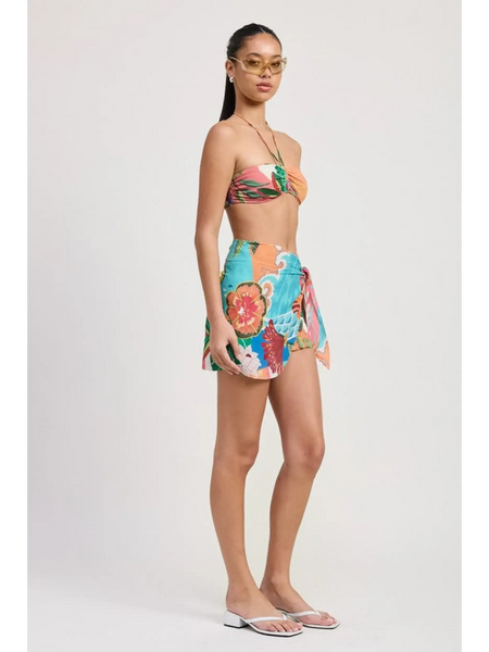 Emory Park model wearing a colorful Tangerine Bikini Bralette paired with a floral wrap skirt and flip-flops
