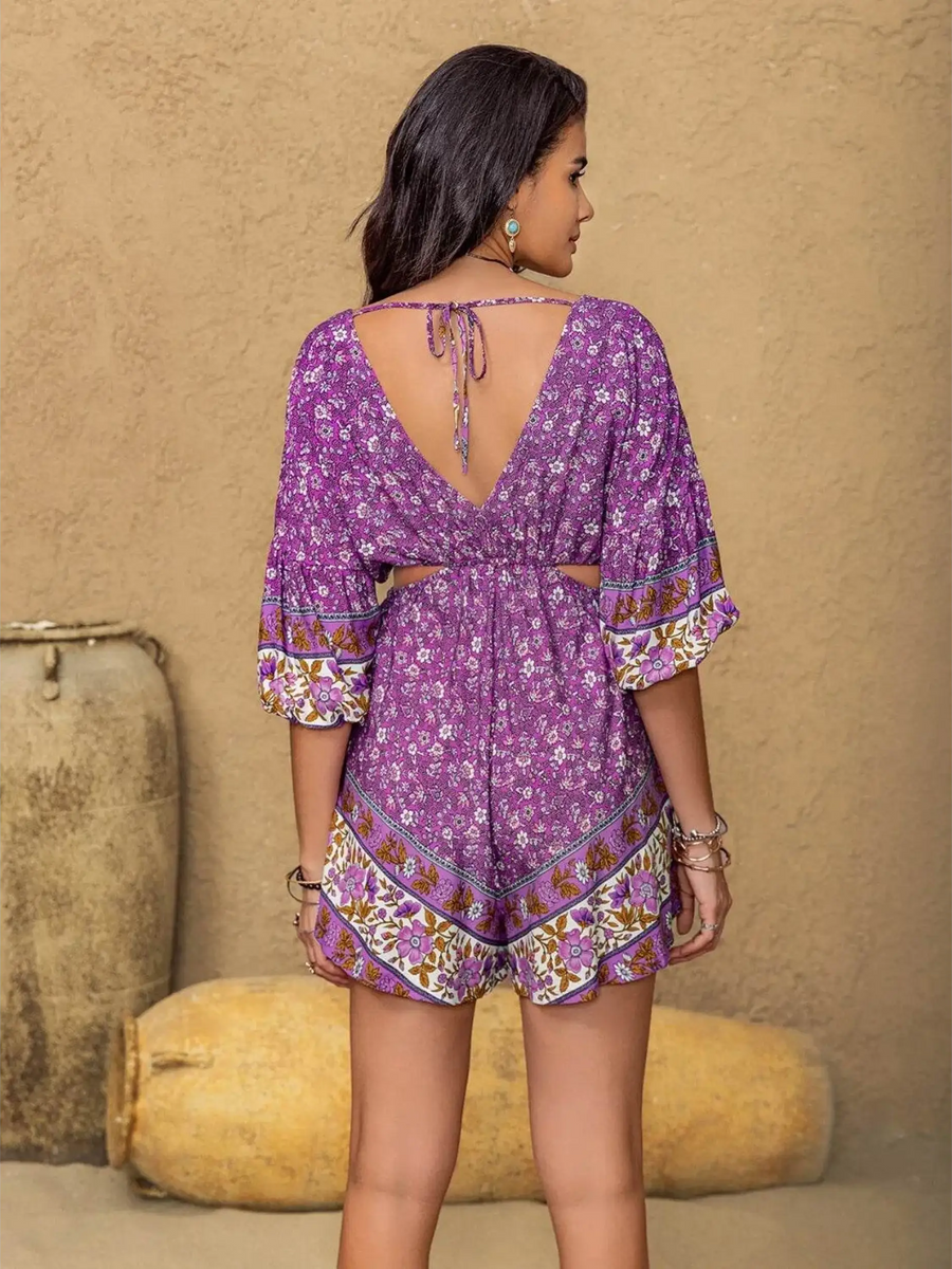 Babe Beachwaer tied front cutout romper in purple floral print with open back and tie detail