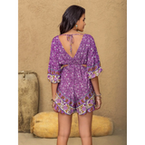 Babe Beachwaer tied front cutout romper in purple floral print with open back and tie detail
