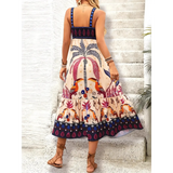 Woman showing back of  tropical summer dress for women midi length with colorful palm and bird print