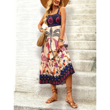 Woman with a hat showing hem detail  tropical summer dress for women with colorful leaf print midi design and adjustable straps