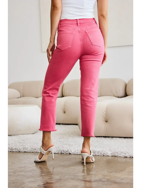 Trendsi pink tummy control high waist jeans worn by woman with white top and heels