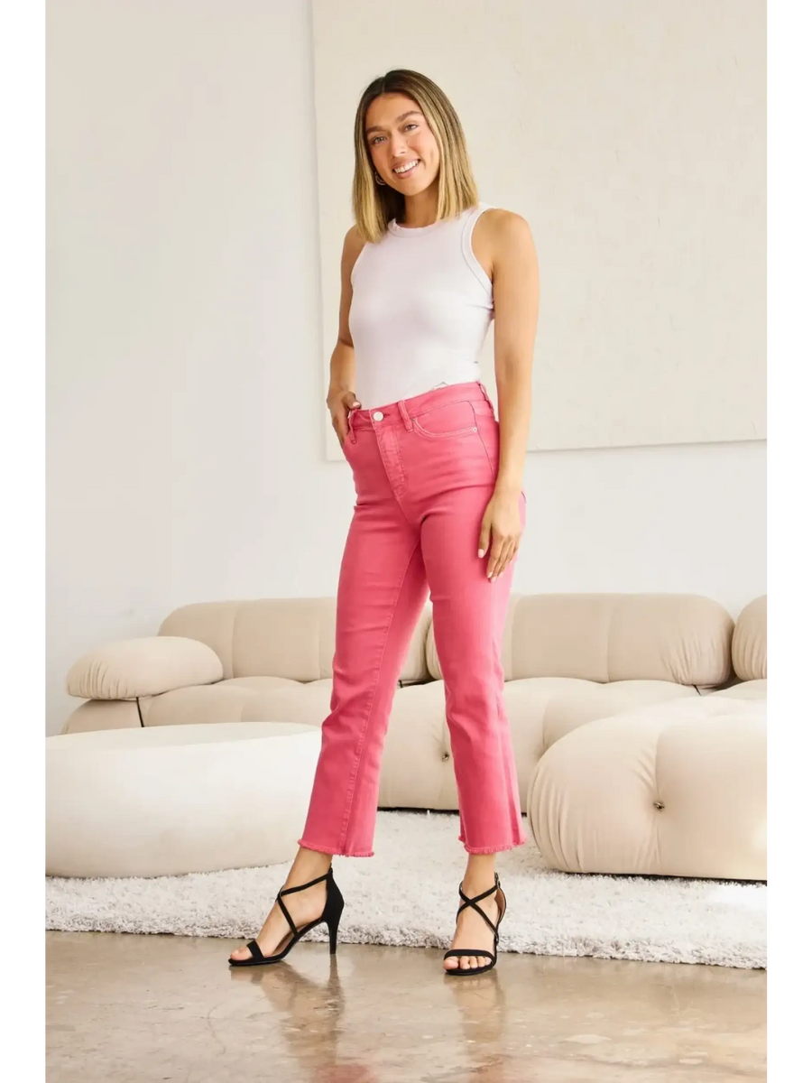 Trendsi pink tummy control high waist jeans worn by woman with white tank top and black heels