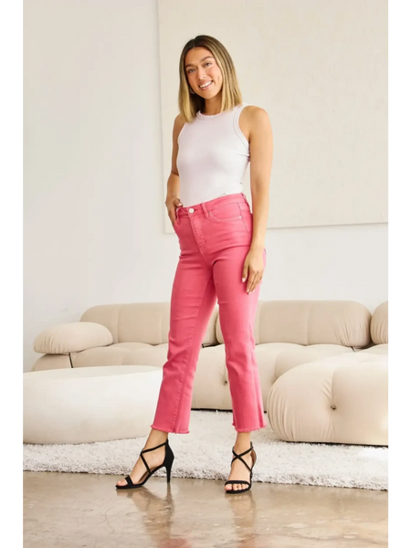 Trendsi pink tummy control high waist jeans worn by woman with white tank top and black heels