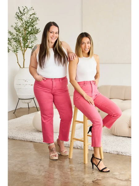 Two women wearing trendy pink tummy control high waist jeans by Trendsi styled with white tops and heels