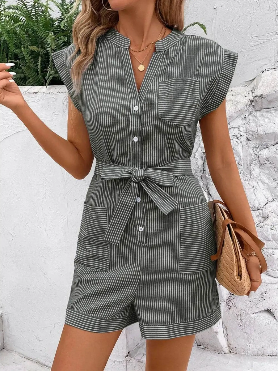 Babe Beachwear striped waist tie romper with buttons and pockets styled with a woven handbag