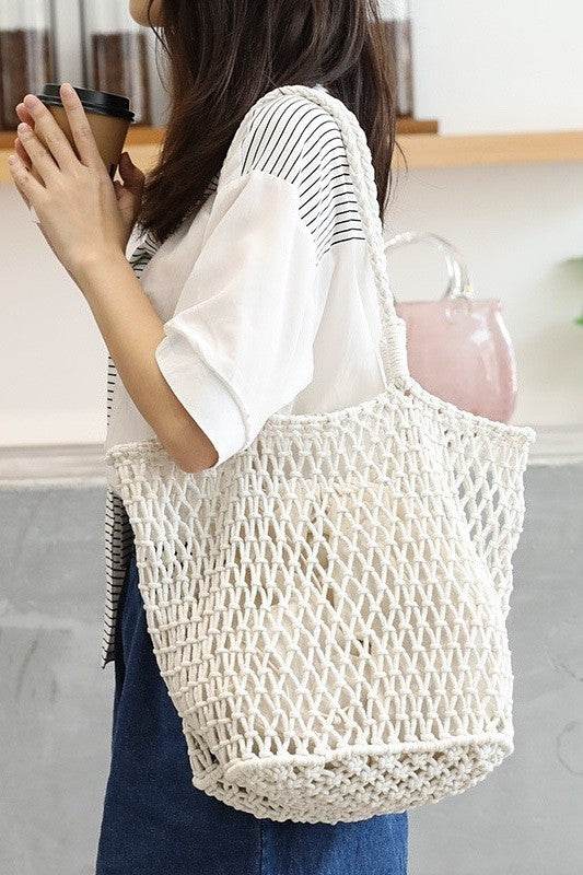 Miss Sparkling white braided net beach tote bag worn by woman holding coffee cup