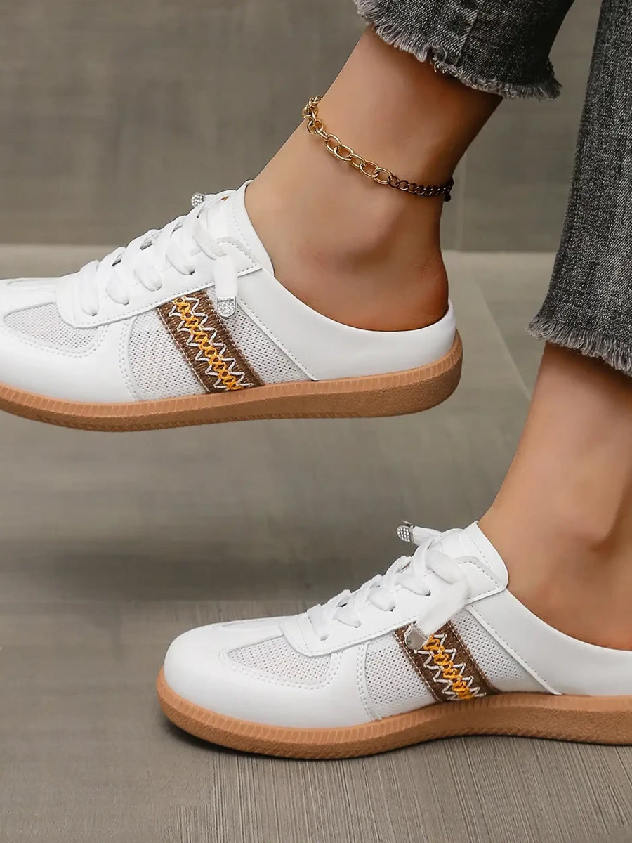 Trendsi white mule sneakers for women with brown detailing and gum soles worn with cropped jeans