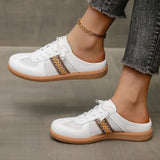Trendsi white mule sneakers for women with brown detailing and gum soles worn with cropped jeans
