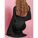 Trendsi black maxi dress with long bell sleeves shown from back with wavy hair white swimsuit cover up long sleeve