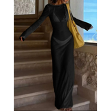 Trendsi black maxi dress worn by woman descending stairs, styled as white swimsuit cover up long sleeve