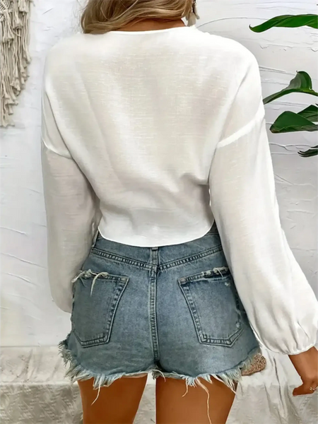 Trendsi white tie front long sleeve cropped top with balloon sleeves worn with distressed denim shorts