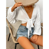Trendsi white tie front long sleeve cropped top paired with distressed denim shorts