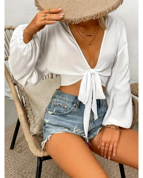 Trendsi white tie front long sleeve cropped top paired with distressed denim shorts