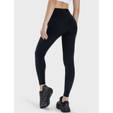 women's active leggings with pockets in black worn by model with athletic black shoes