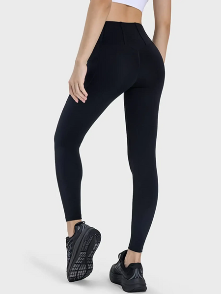 women's active leggings with pockets in black worn by model with athletic black shoes