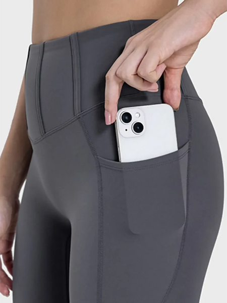  women's active leggings with pockets in dark gray showing phone stored in side pocket