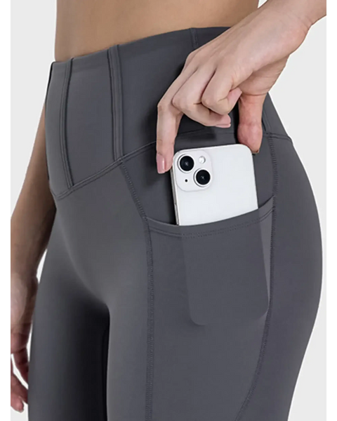  women's active leggings with pockets in dark gray showing phone stored in side pocket