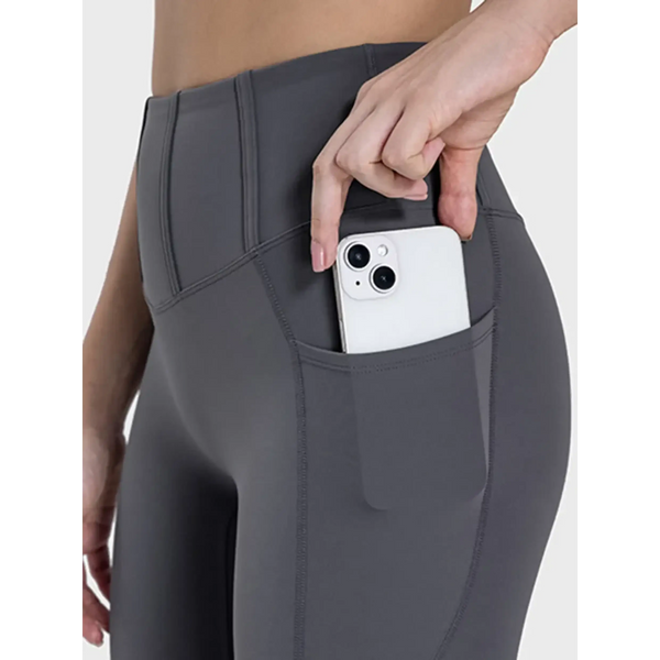  women's active leggings with pockets in dark gray showing phone stored in side pocket