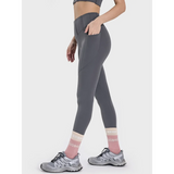 women's active leggings with pockets in gray worn with running shoes and socks