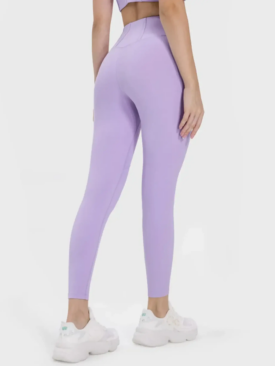 Trendsi women's active leggings with pockets in lavender shown from the back on a model