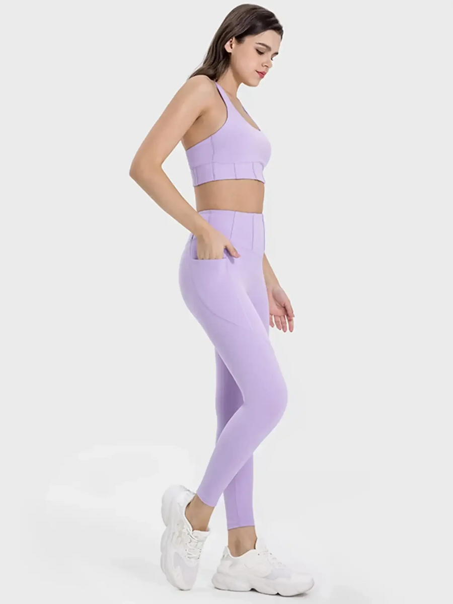 Trendsi women's active leggings with pockets in lavender shown worn with matching sports bra and white sneakers