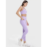 Trendsi women's active leggings with pockets in lavender shown worn with matching sports bra and white sneakers