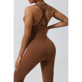 Babe Beachwear women's athletic crisscross jumpsuit in brown showing back view with tattooed arms