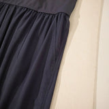 Close-up of black Trendsi women's beach jumpsuit showing fabric texture and stitching details