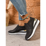Trendsi women's breathable wedge sneakers in black with white sole and gold accent worn with jeans