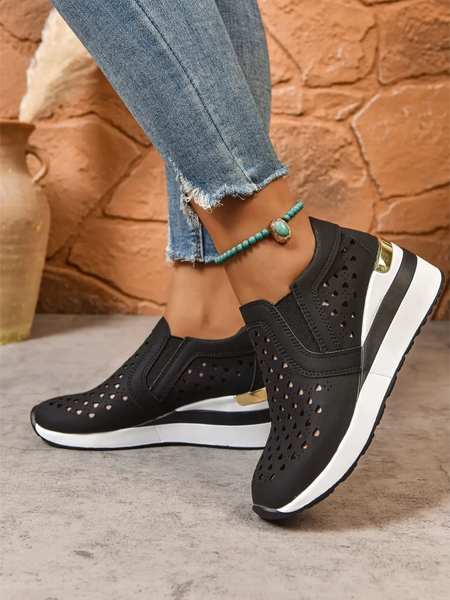 Trendsi women's breathable wedge sneakers in black with white sole and gold accent worn with jeans