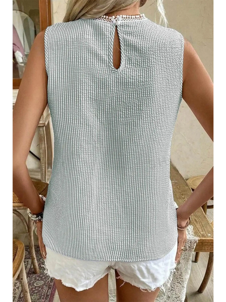 Back view of Babe Beachwear women's casual sleeveless shirt in light textured fabric paired with white shorts