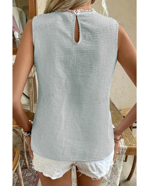 Back view of Babe Beachwear women's casual sleeveless shirt in light textured fabric paired with white shorts