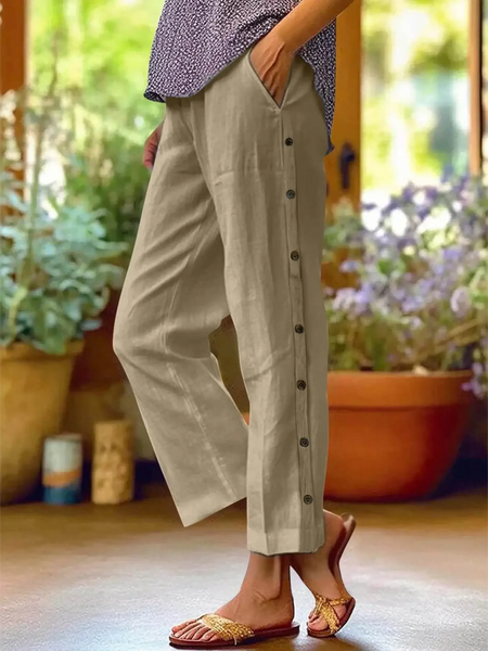 Babe Beachwaer women's casual white vacation pants with button detail on side worn with sandals