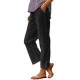 Babe Beachwear black pants with side buttons modeled on woman wearing slippers and purple top