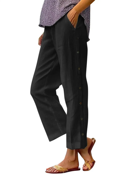 Babe Beachwear black pants with side buttons modeled on woman wearing slippers and purple top