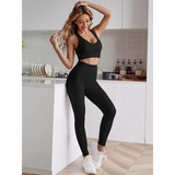 Trendsi women's compression leggings set in black with matching crop top worn in modern kitchen
