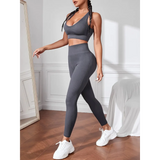 Trendsi women's compression leggings set in dark gray worn with matching sports bra and white sneakers