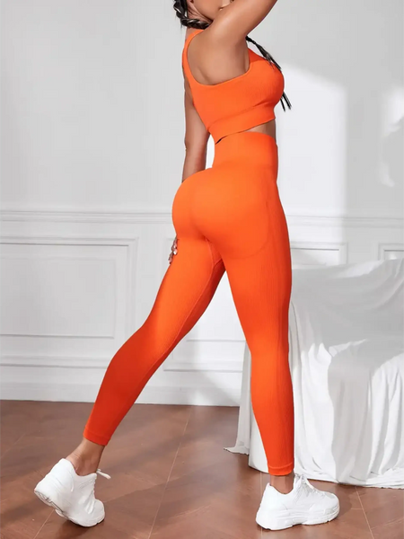 Trendsi women's compression leggings set in bright orange with matching crop top and white sneakers
