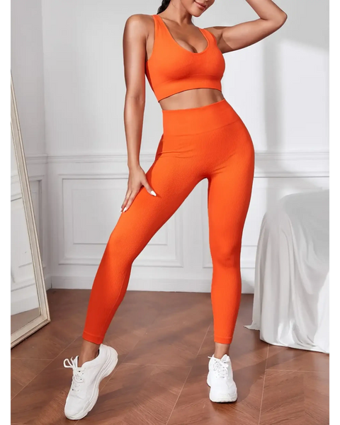 orange women's compression leggings set in bright orange with matching sports bra and white sneakers