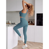 Trendsi women's compression leggings set in teal worn by woman posing in modern kitchen