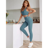 Trendsi women's compression leggings set in blue worn by a woman posing in a modern kitchen