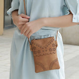 MKF Collection by Mia K women's crossbody beach bag in tan with floral cutout design and adjustable strap
