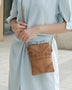 MKF Collection by Mia K women's crossbody beach bag in tan with floral cutout design and adjustable strap
