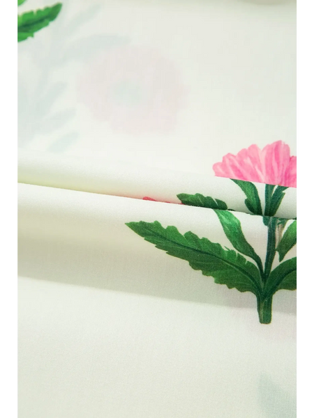 Close-up of floral fabric print with green leaves and pink flowers for women's flutter sleeve vacation dress
