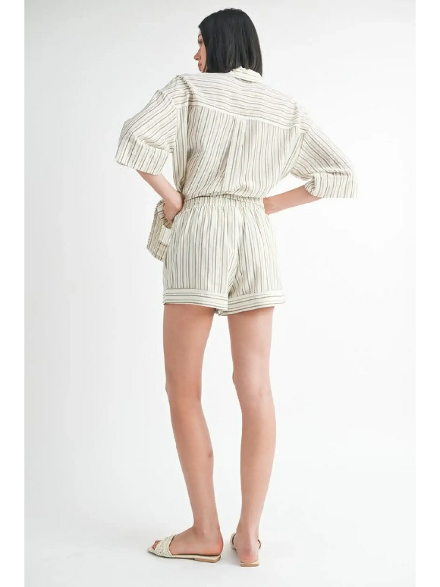 Back view of woman wearing Emory Park women's linen shorts with striped matching shirt and sandals