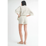 Back view of woman wearing Emory Park women's linen shorts with striped matching shirt and sandals